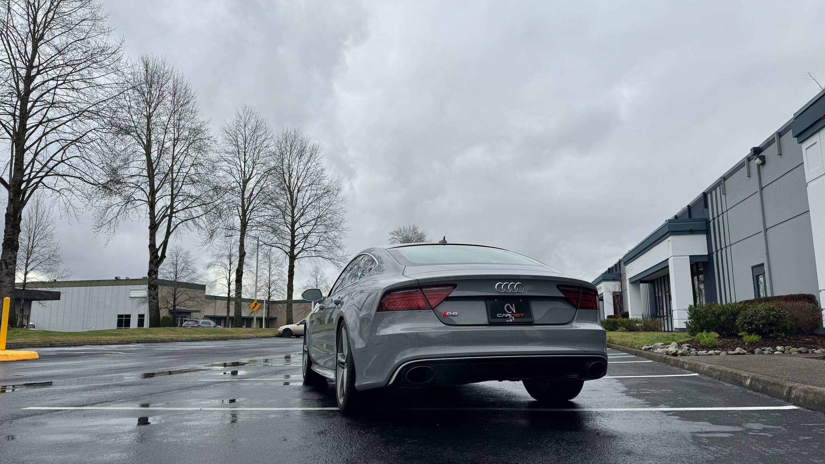 Audi RS 7 rear three-quarter view on wet pavement in Tukwila